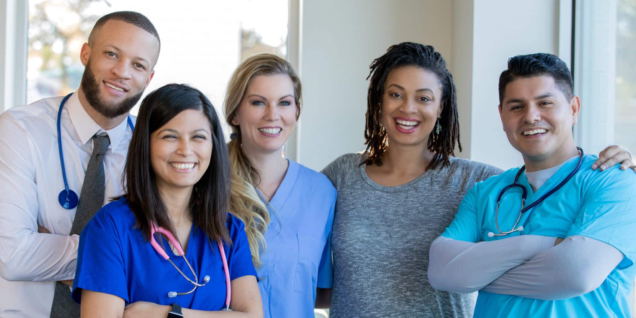 Diverse Healthcare Team Of Doctors And Nurses Standing In Hospital