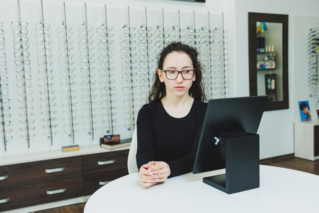 Premium Photo Optics Shop A Young Woman Chooses Glasses In An Optical